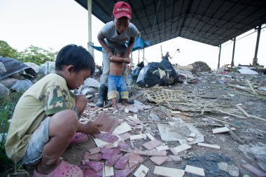 BALI, INDONESIA  APRIL 11: Poor from Java island working in a scavenging at the dump on April 11, 2012 on Bali, Indonesia. Bali daily produced 10,000 cubic meters of waste.